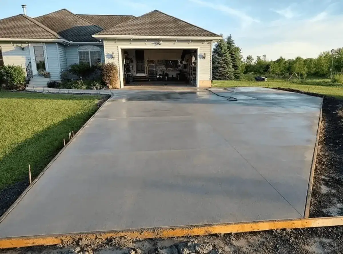 New concrete driveway poured to an attached garage in Orchard Park NY — Liberty Pour Concrete