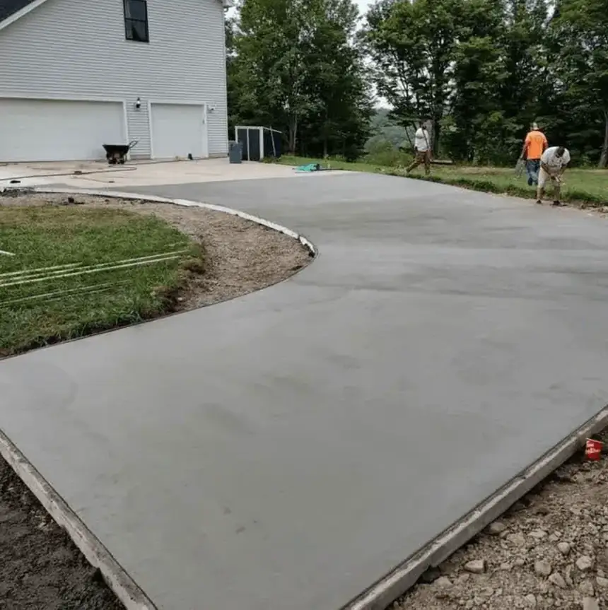 Liberty Pour Concrete crew finishing a freshly poured concrete driveway in Erie County NY