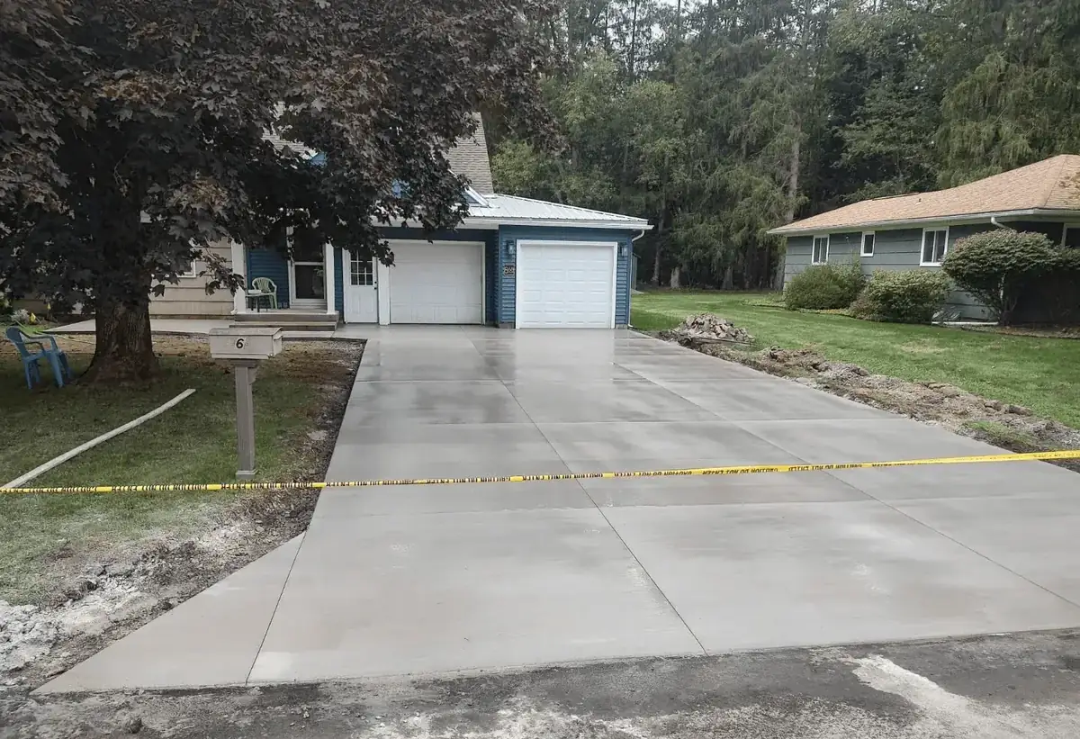 Finished concrete driveway with clean control joints at a home in Orchard Park NY by Liberty Pour Concrete