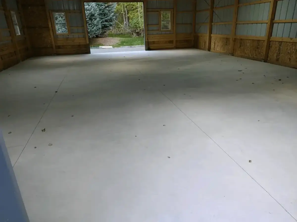 Smooth hard-troweled concrete floor poured inside a pole barn by Liberty Pour Concrete
