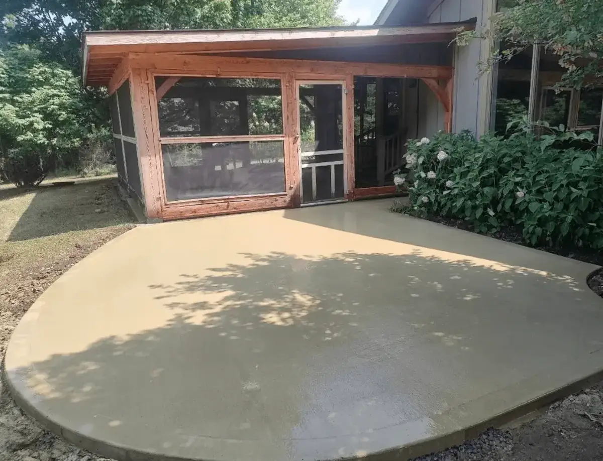 Stained concrete patio with a rounded edge outside a screened porch in East Aurora NY — Liberty Pour Concrete